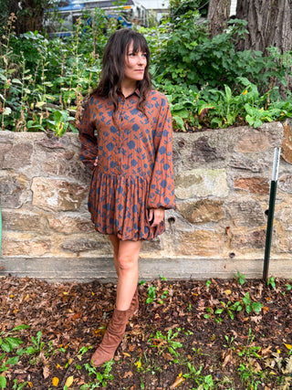 Rust floral bubble hem mini dress with long sleeves, styled with brown boots for fall