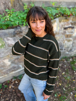 Crew neck sweater in a deep Olive color with camel + cream stripe accents

