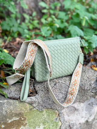 Woven crossbody handbag with guitar strap